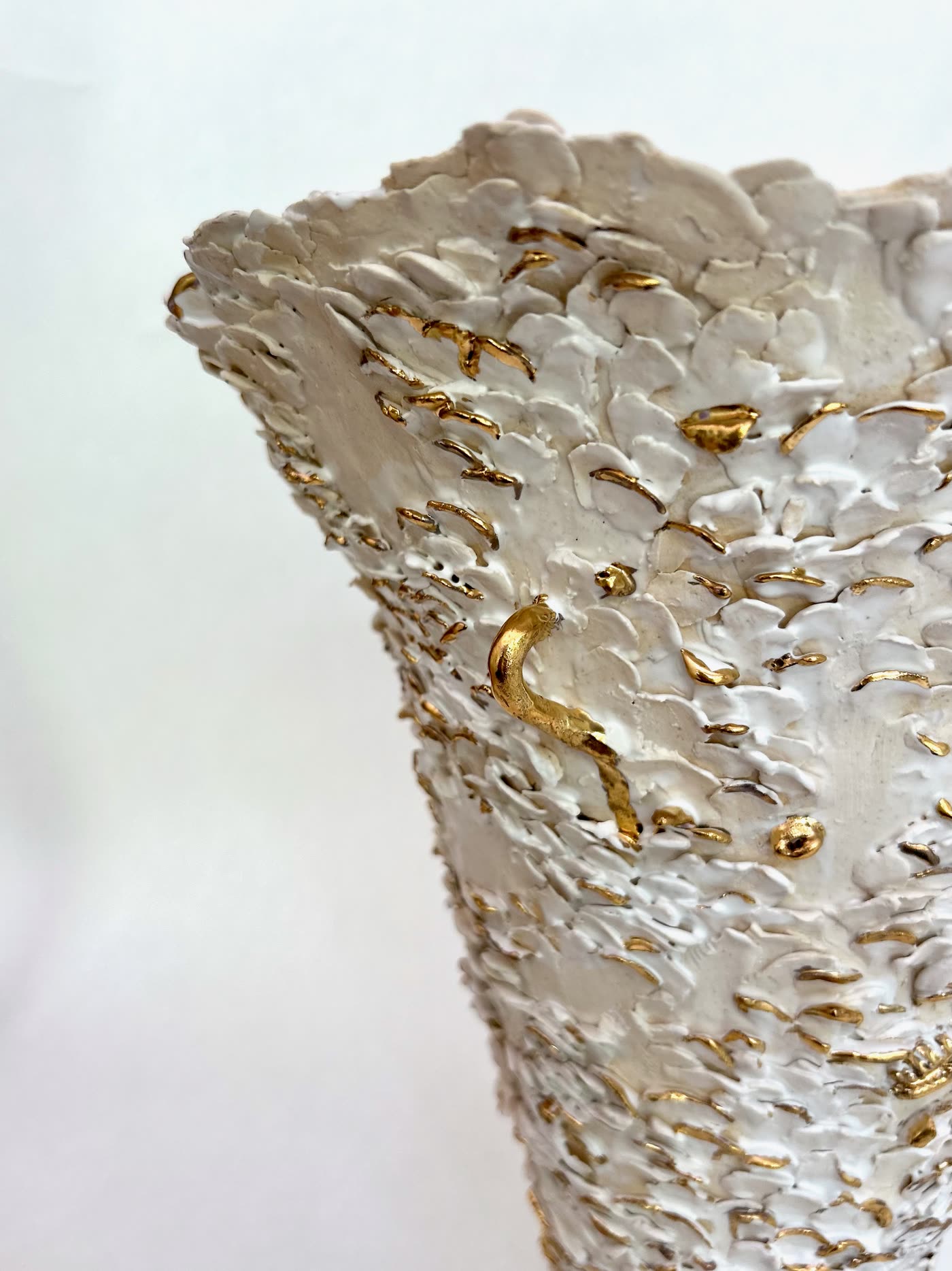 Close detail of the layered white surface and gold marks on the vessel by Consuelo Becerra, view 7 of 8