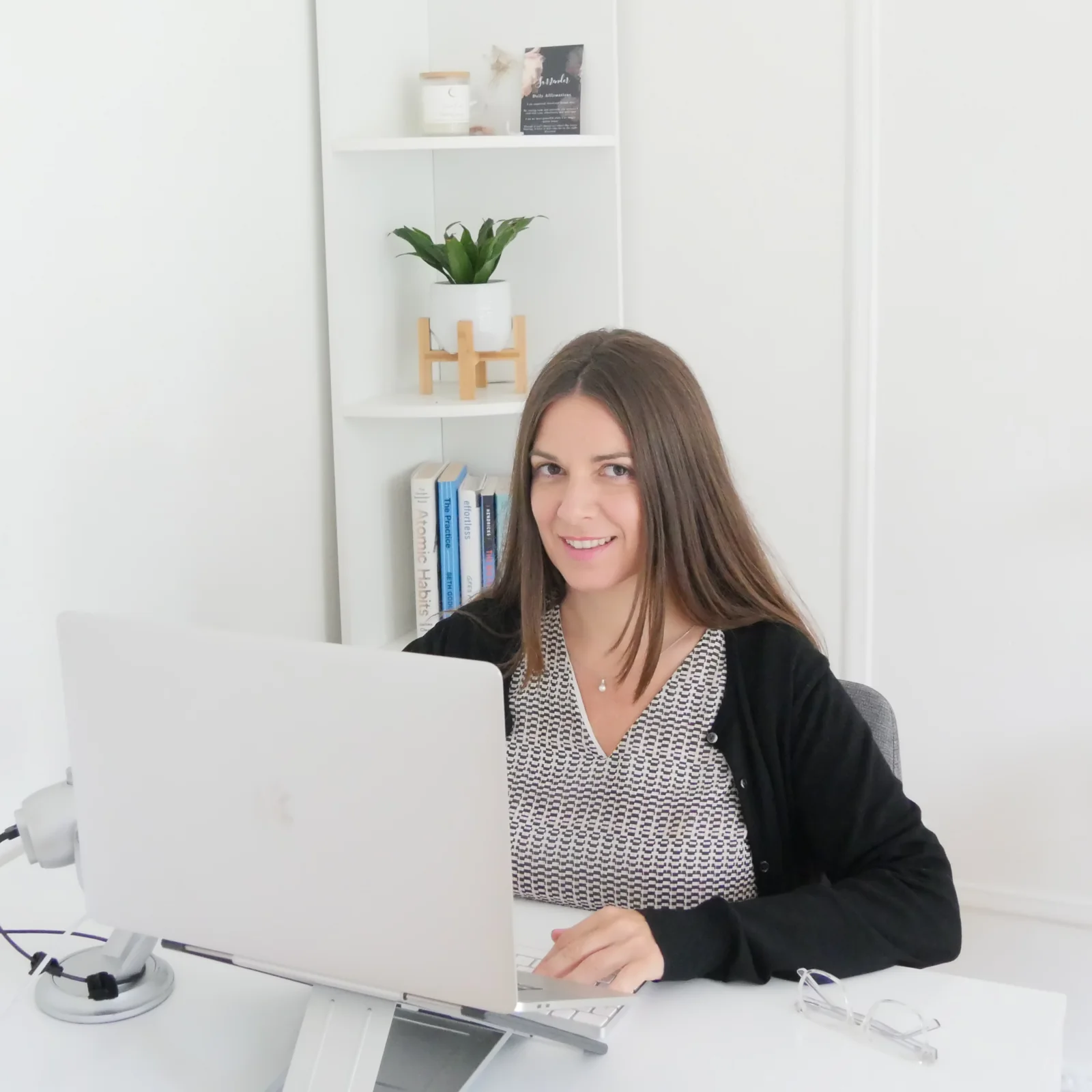 Muriel Touati working at her desk in her New York studio, where the agency's work is produced