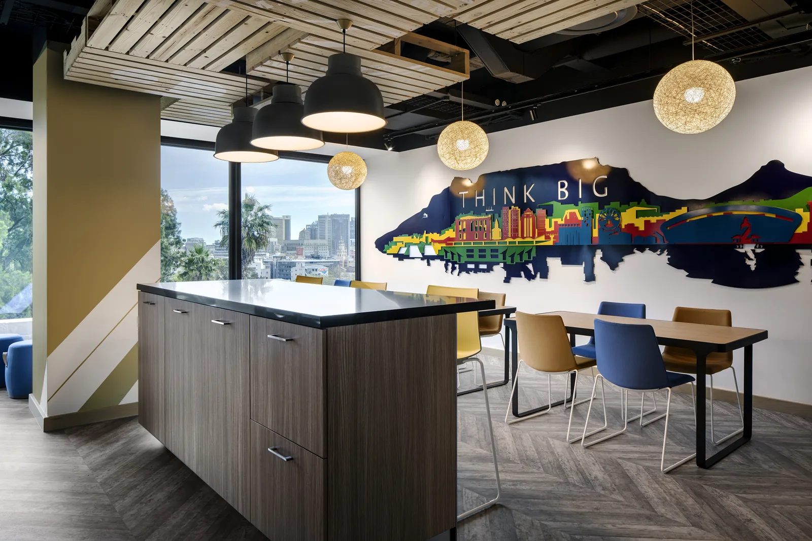 Design Partnership Interior Designers Cape Town. Workplace breakout with a painted mural and island seating Design in Cape Town.