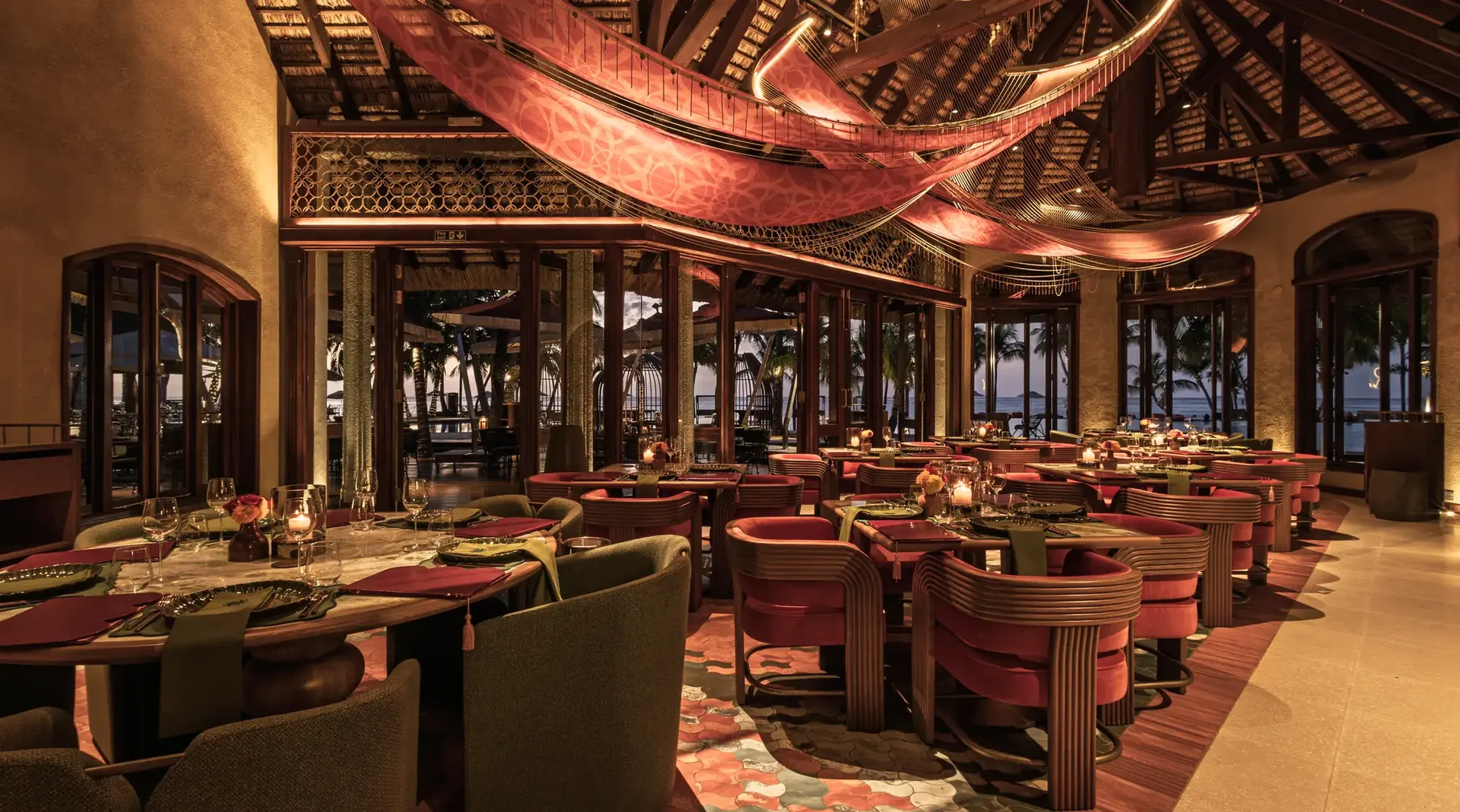 Rangoli restaurant interior with a draped fabric ceiling and warm layered lighting in Mauritius.
