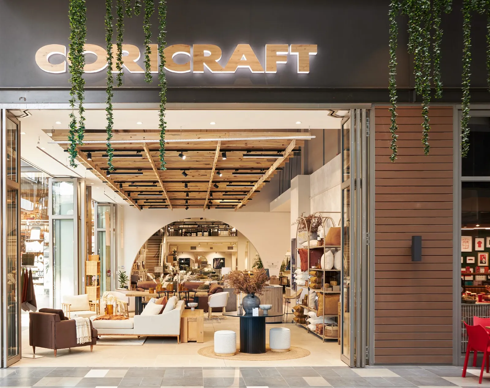 Coricraft storefront with illuminated brand signage and an open shopfront entrance.
