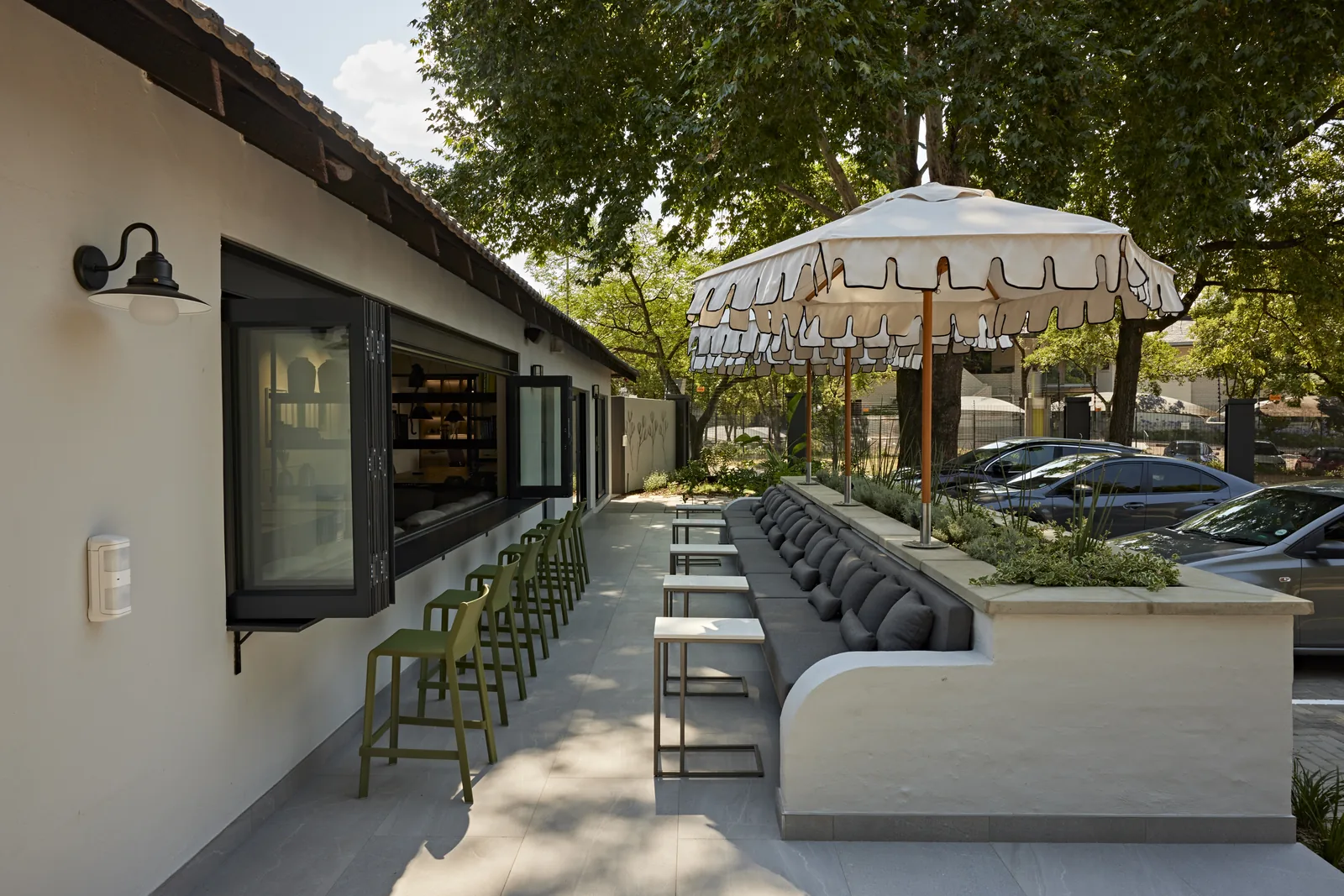 Design Partnership Interior Designers Johannesburg. Outdoor terrace seating under umbrellas design in South Africa.