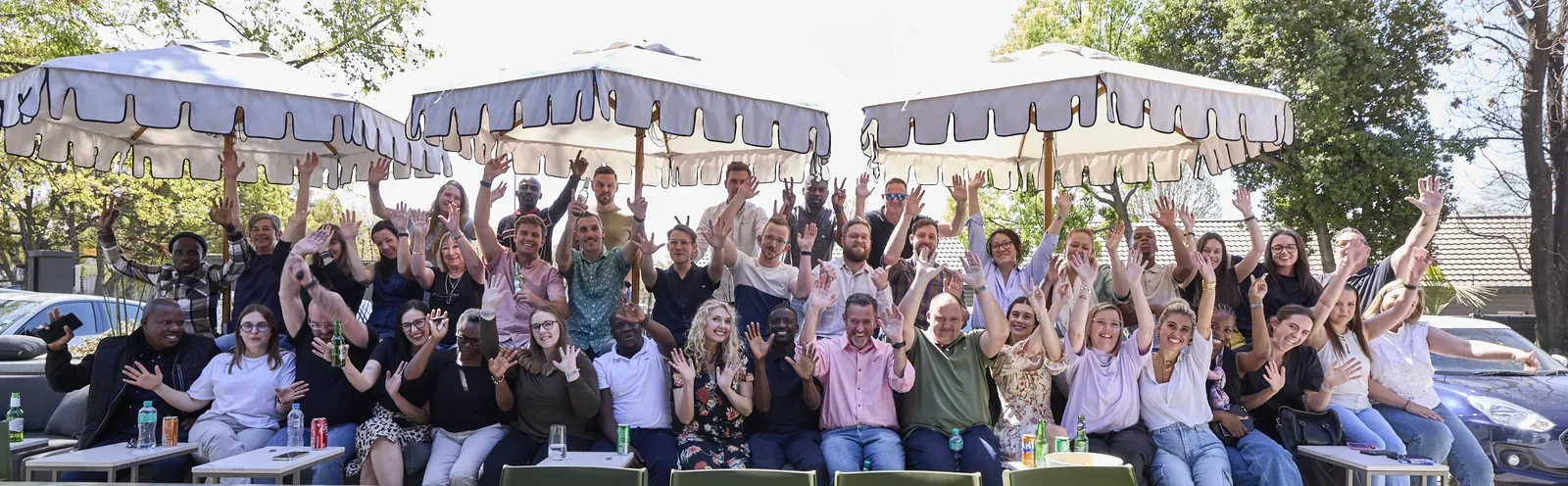 The Design Partnership team together at an outdoor team celebration.