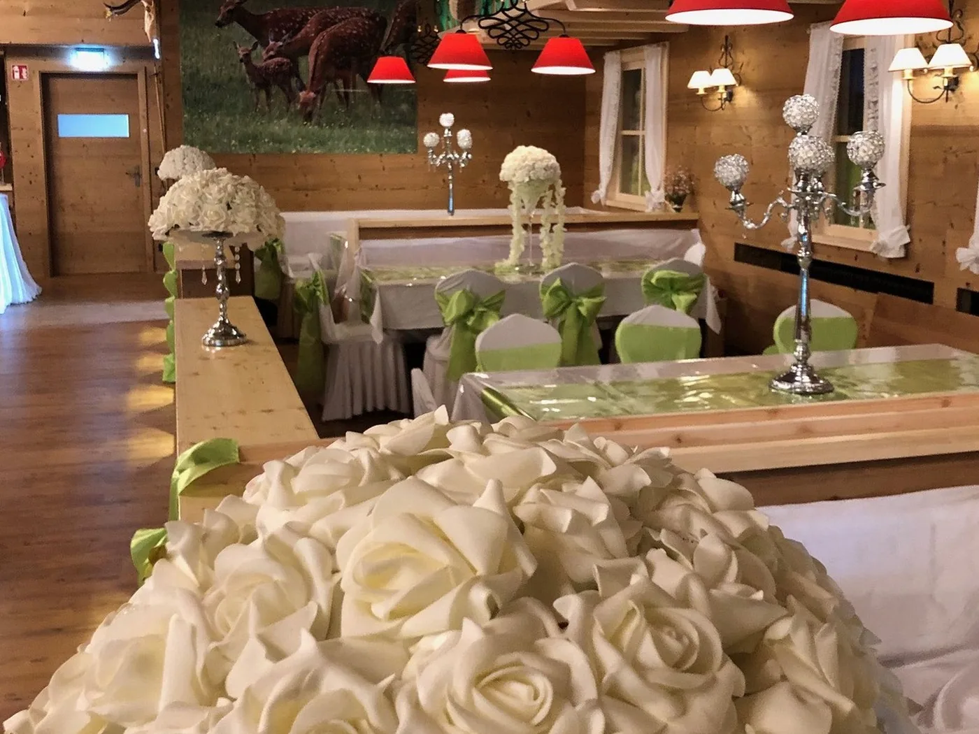 Hochzeitsdeko mit Rosenkugel und Kerzenleuchtern in der Hirschalm