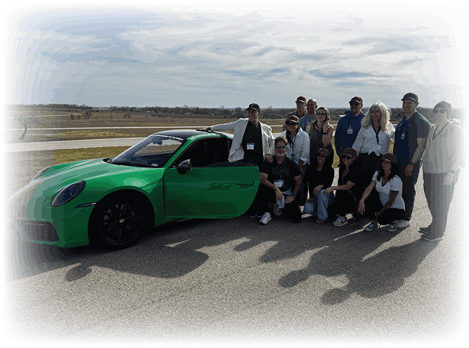 Chrysalis programme participants gathered beside a green Porsche on an airfield