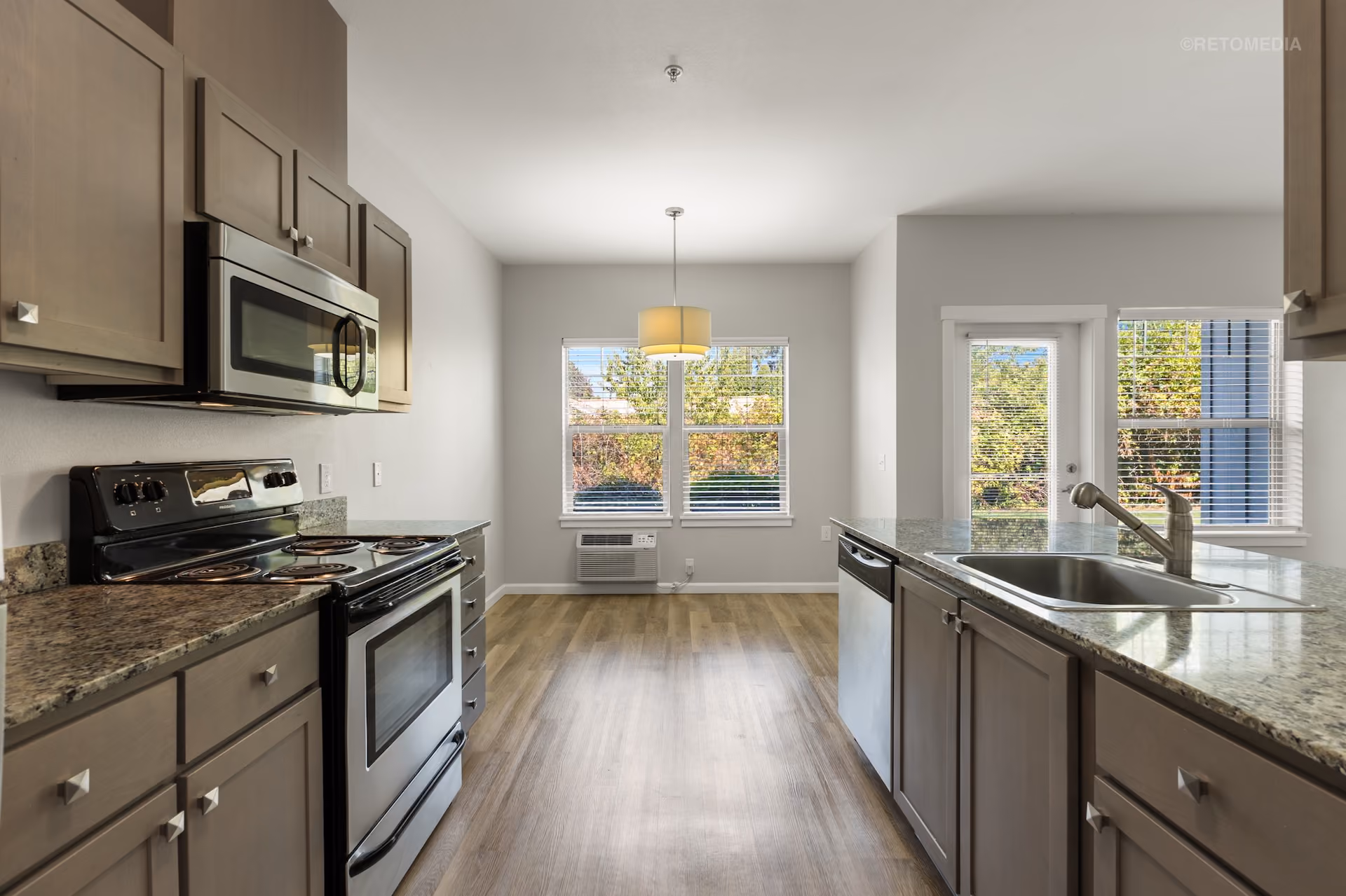 Cozy kitchen with stainless steel appliances at Keizer Station Apartments in Keizer, Oregon