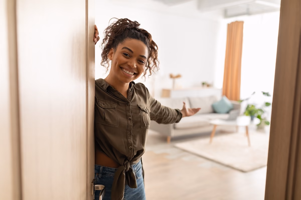 Woman opening apartment door
