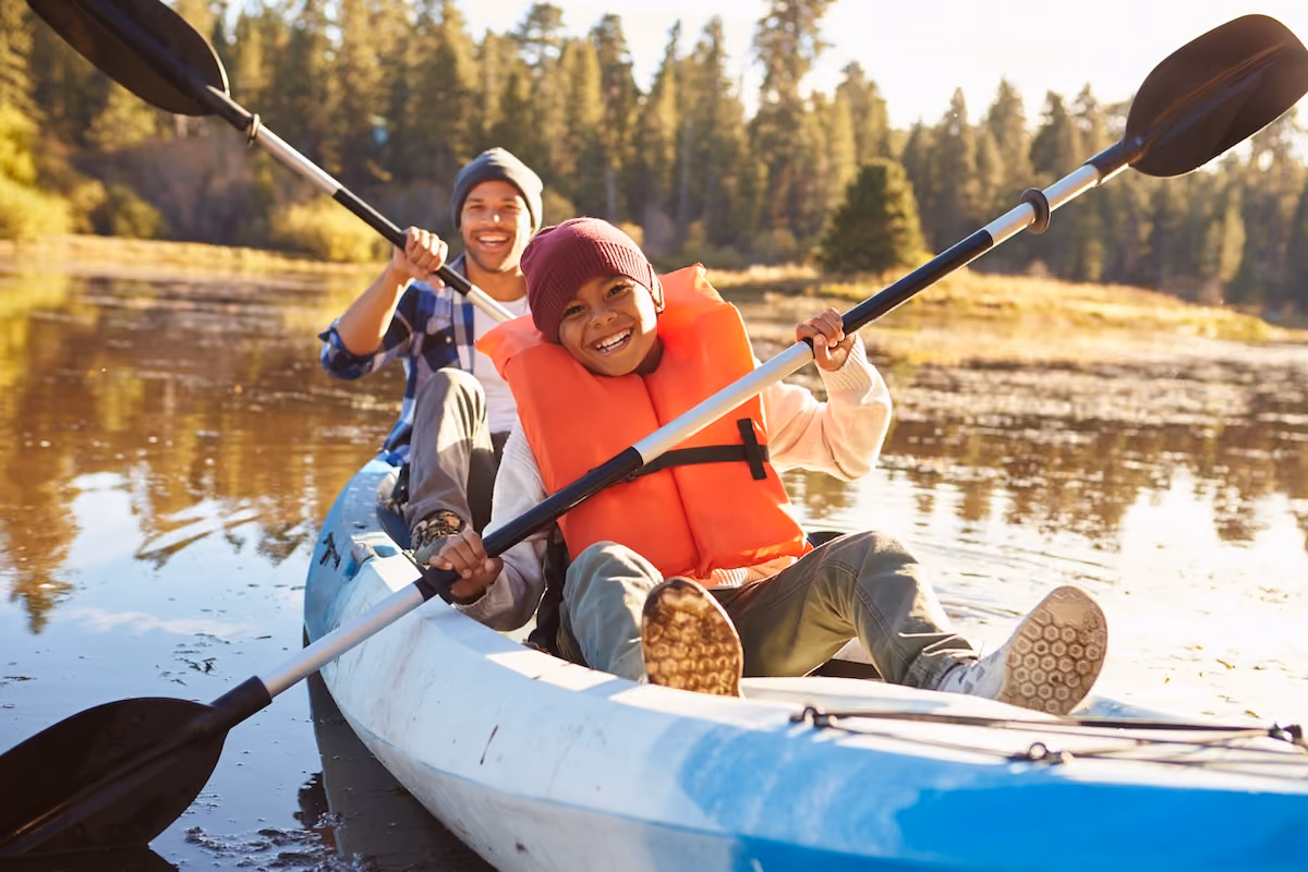 son and father kayaking 