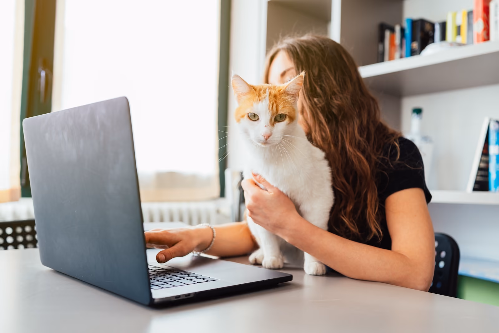 Woman and cat at computer