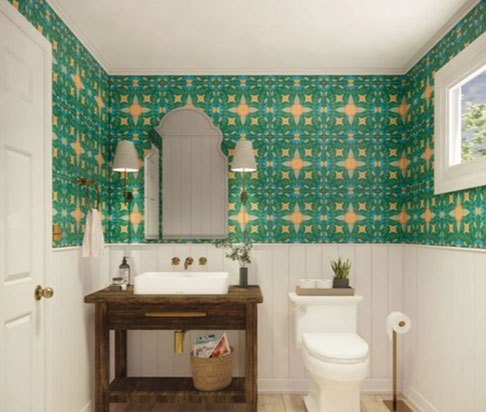 Bathroom with green patterned wallpaper, wooden vanity, and brass fixtures