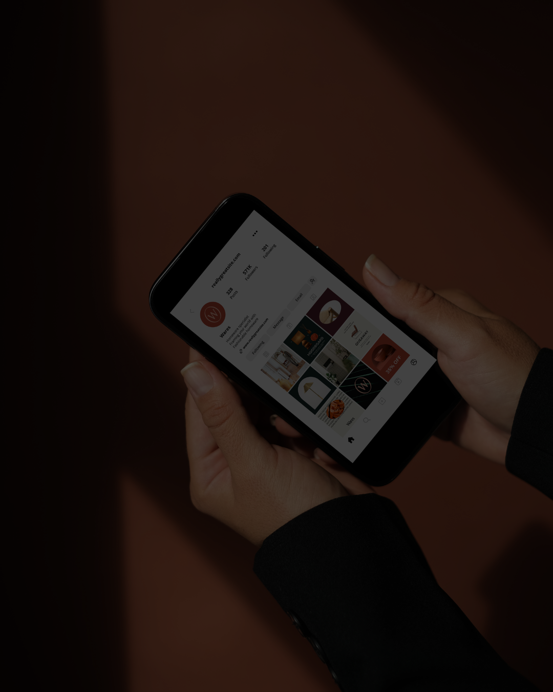 Two hands holding a smartphone displaying an Instagram profile page for Waree, a homeware specialist with 571K followers and posts featuring home decor and mood board images on a dark brown background.