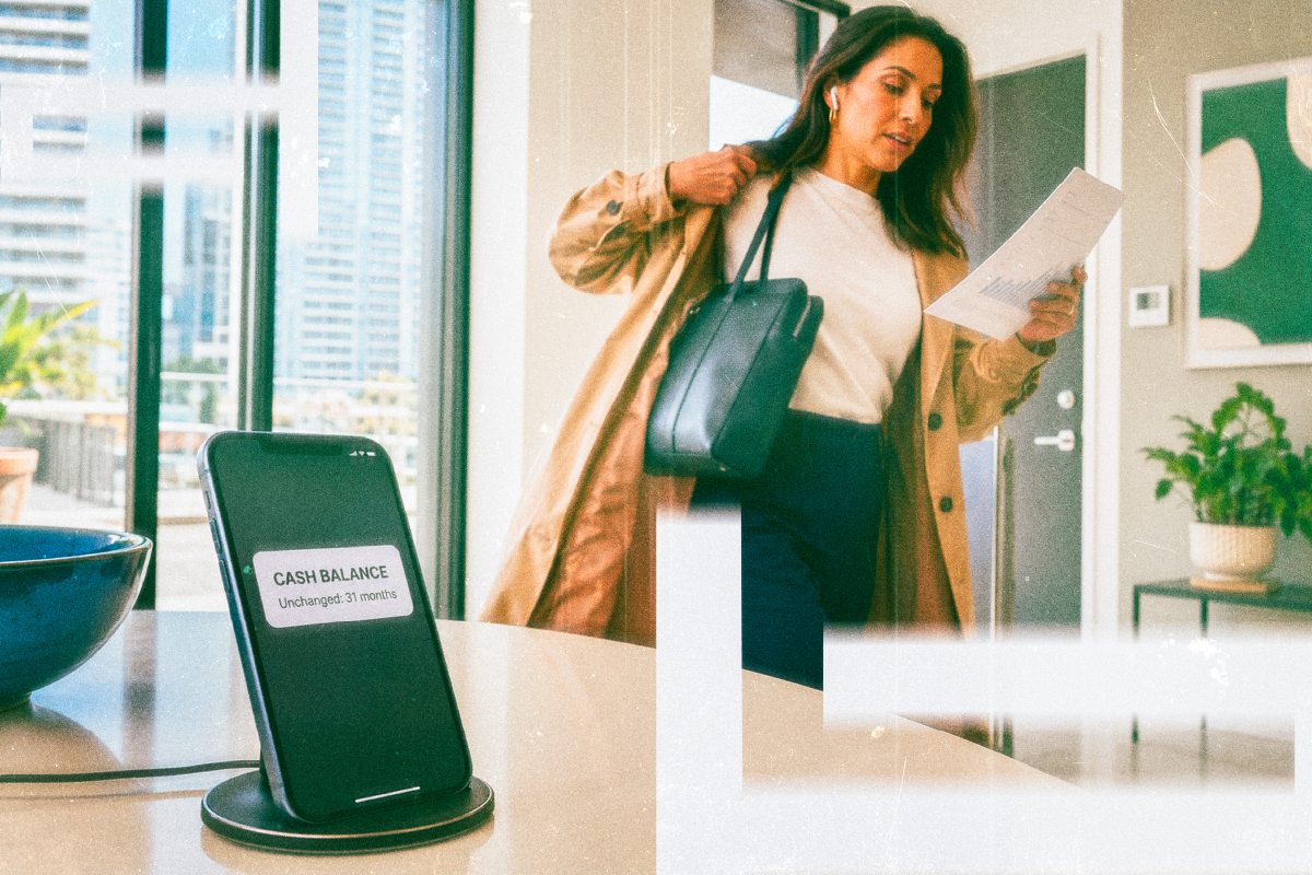 Phone notification about a cash balance that has sat unchanged, with a professional reviewing papers nearby.
