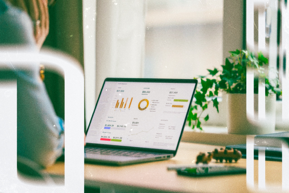 Laptop on a desk showing a financial measurement dashboard.