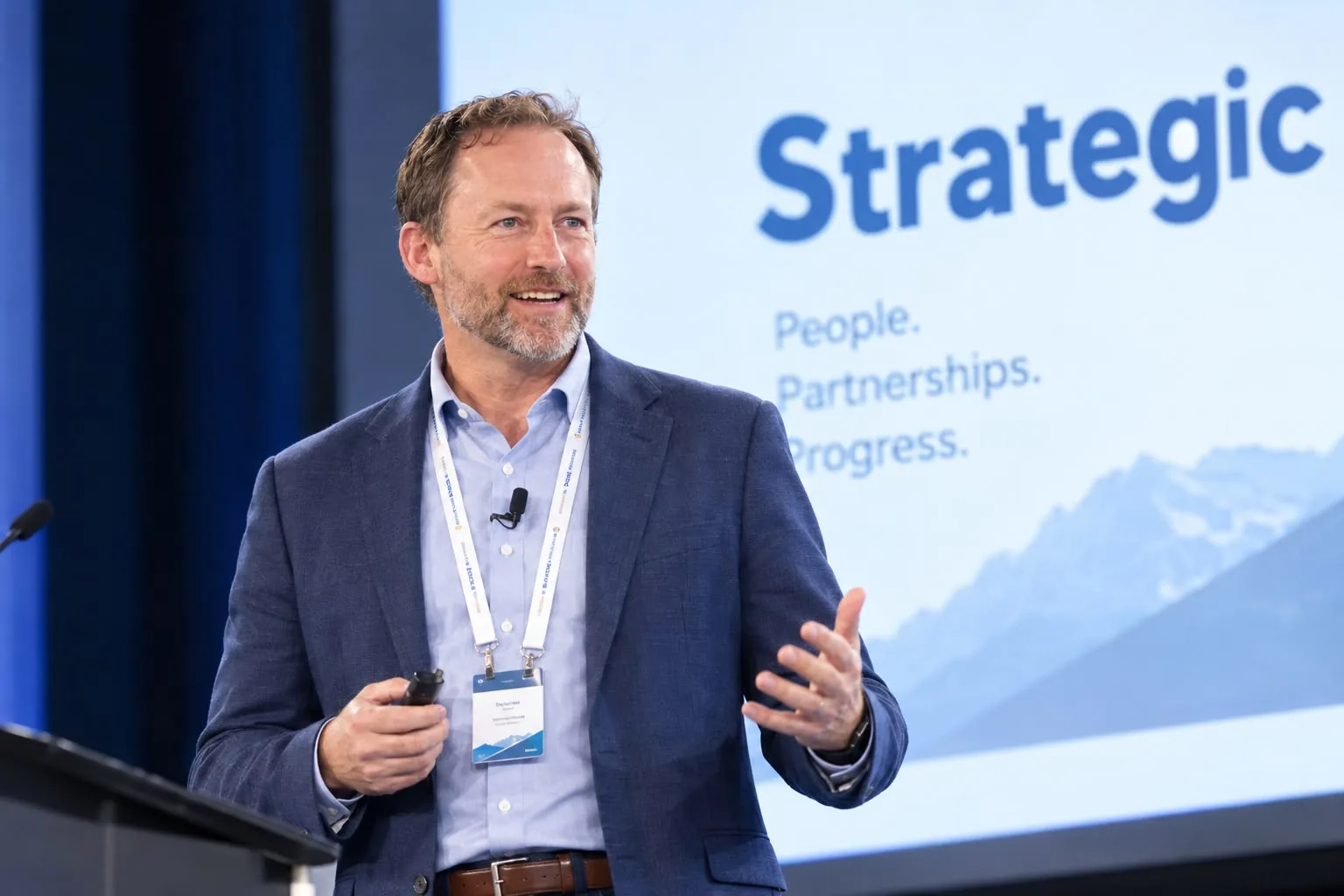 Chris Woodward speaking on stage at a strategic business conference