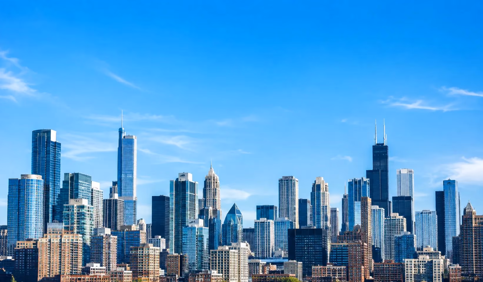 City skyline of office towers under a clear blue sky