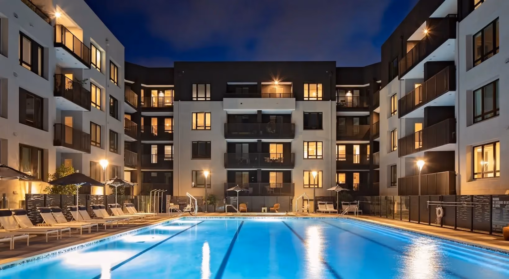 Swimming pool and lounge seating at night