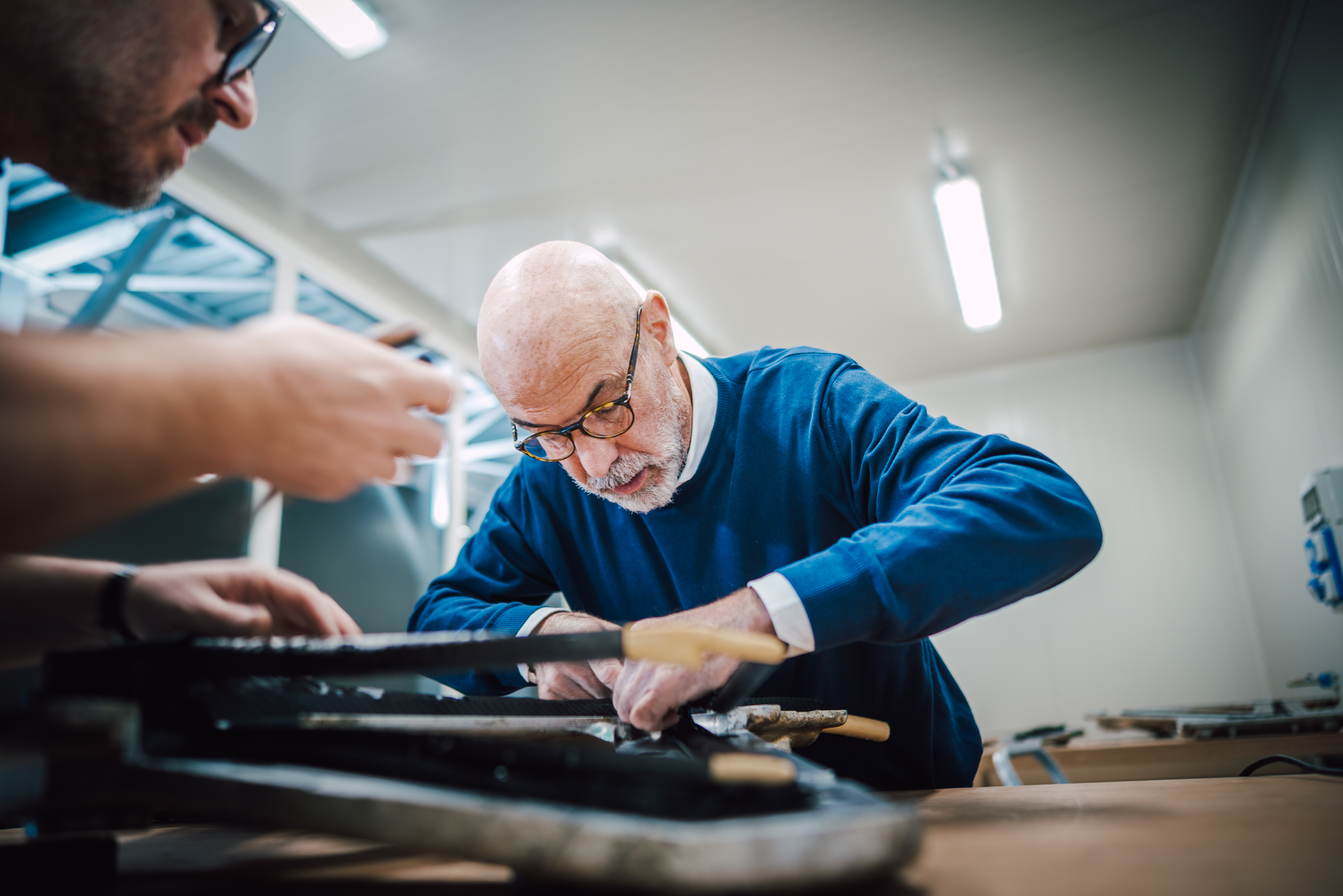 A craftsman working at the layup table in the SWI workshop