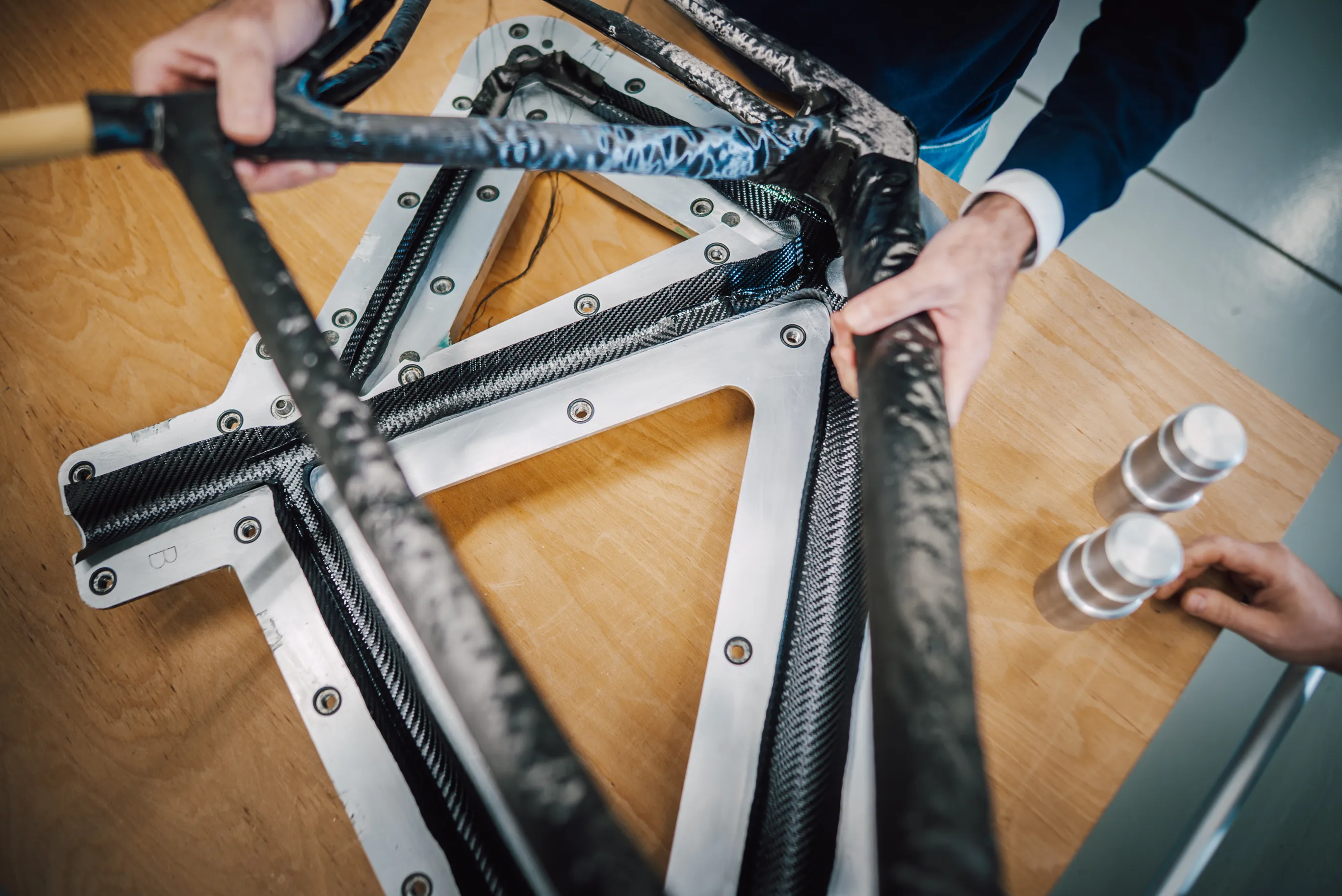 A SWI craftsman finishing a carbon frame by hand