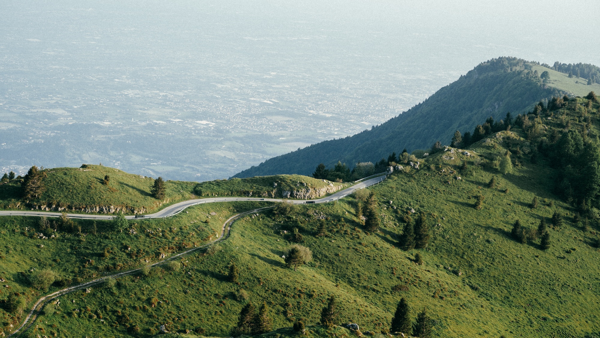 The road down from Monte Grappa with the Veneto plain beyond