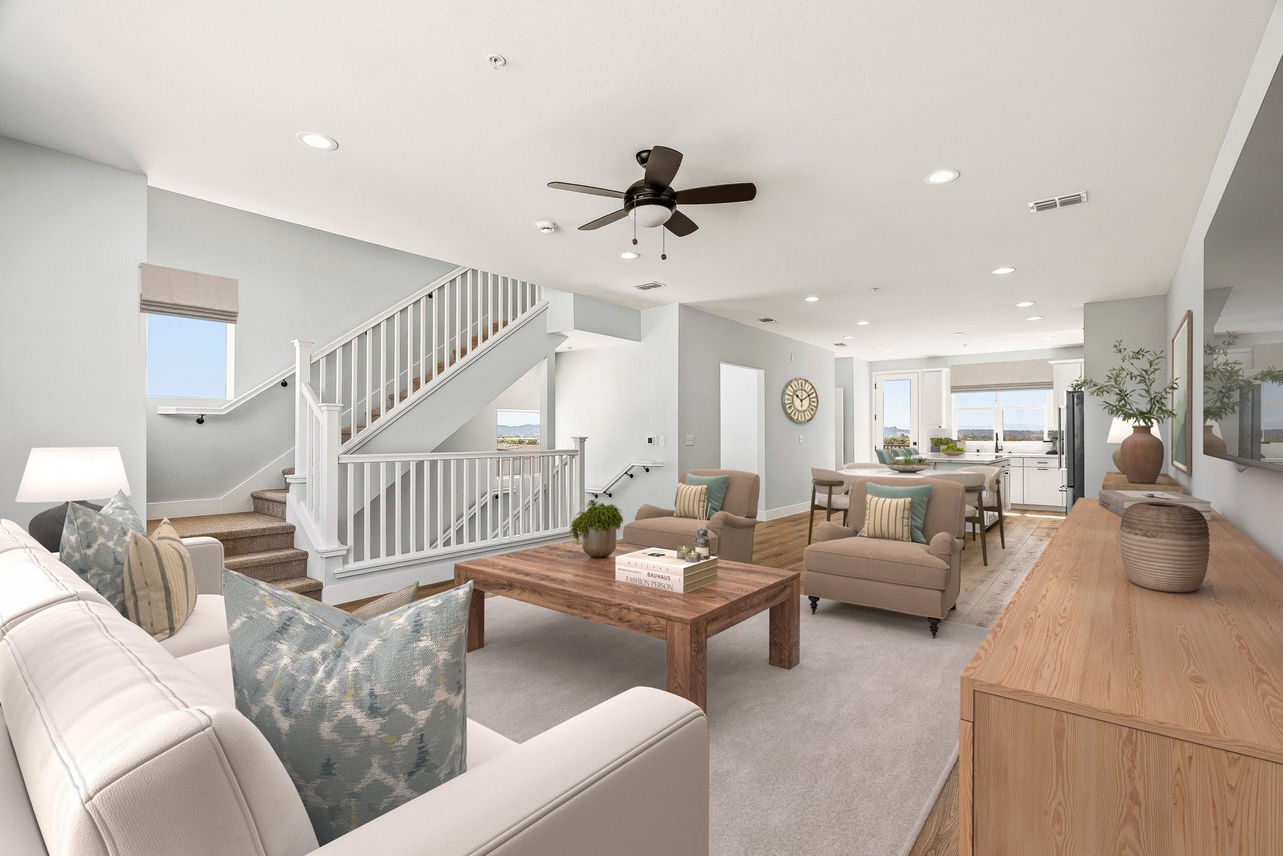 Great room at Hillcrest Residences with Craftsman stair railing, wide-plank flooring and recessed lighting