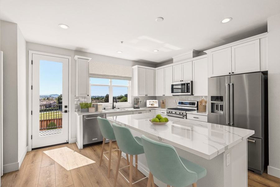 Kitchen with quartz island and Shaker cabinetry in a finished Encanto at Hillcrest Residences