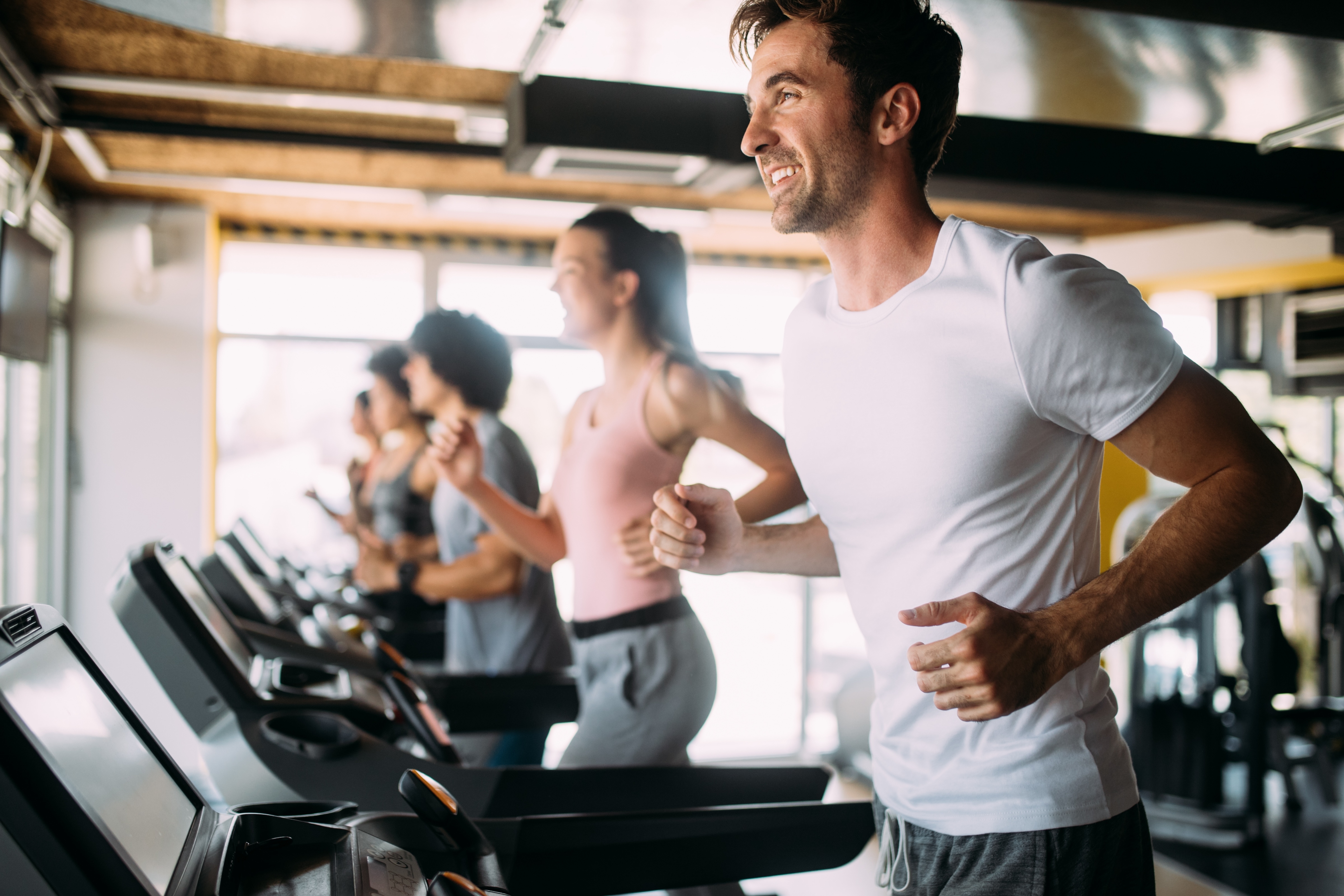 People running on treadmill stock image