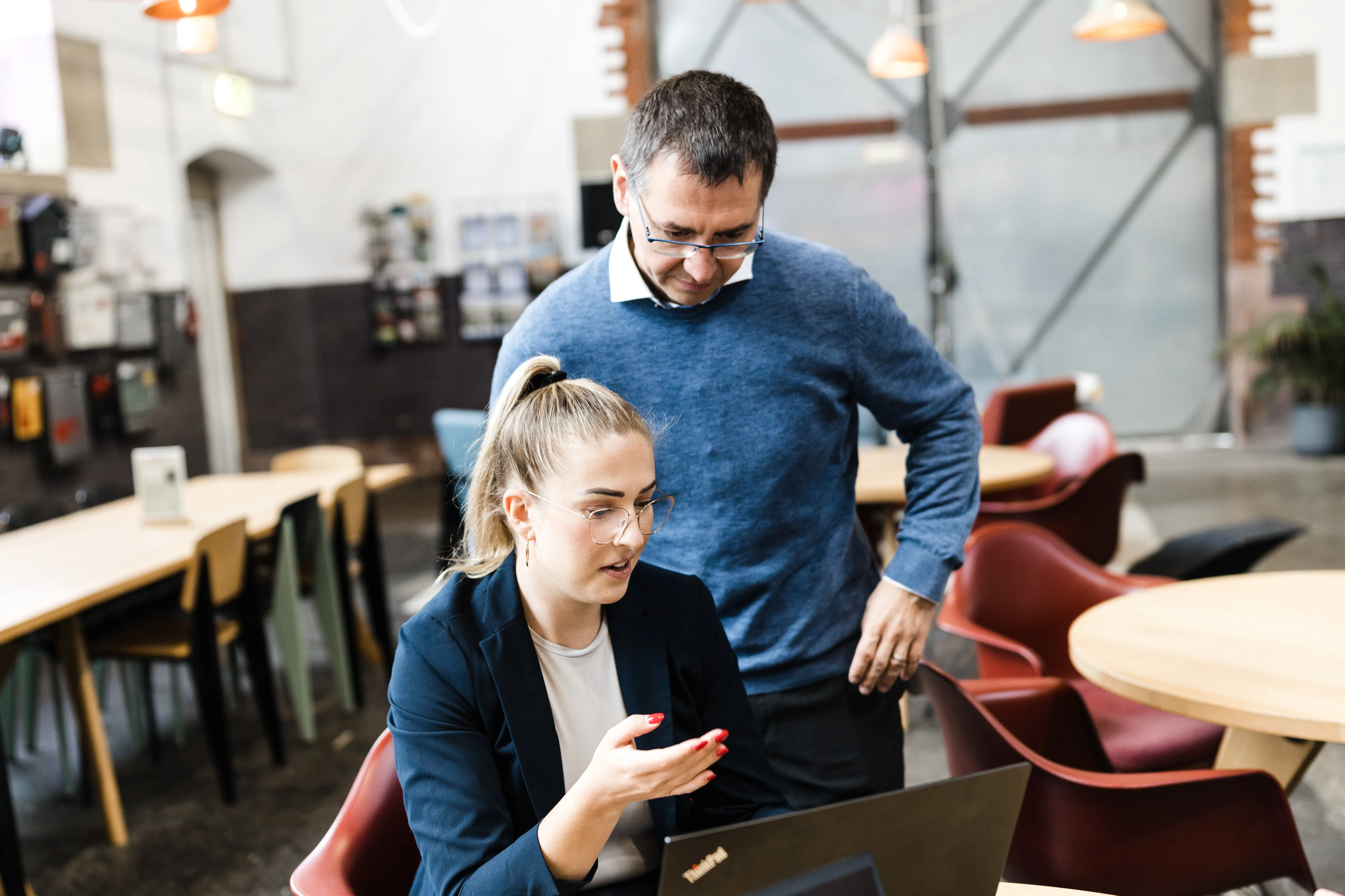 Beraterin und Kollege besprechen am Laptop die Ausgangslage eines ERP-Vorhabens