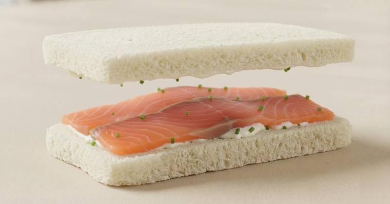 Smoked salmon finger sandwich with chives cream and lime zest