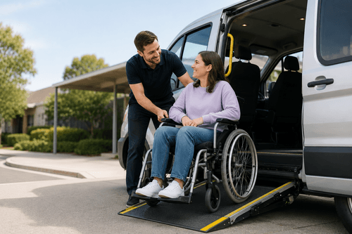 A wheelchair user receiving assistance beside an accessible vehicle ramp