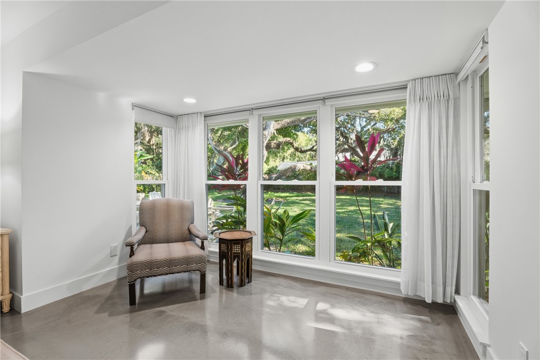 Virtually Staged - Polished concrete flooring, recessed lighting, and expansive windows featuring exterior greenery