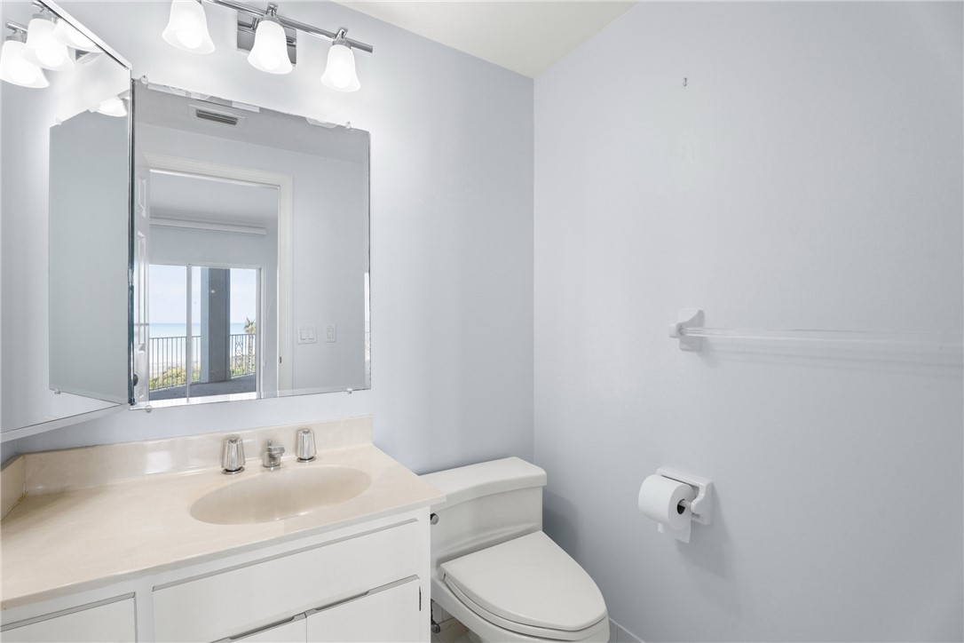 Vanity with light-toned countertop, undermount sink, and chrome fixtures