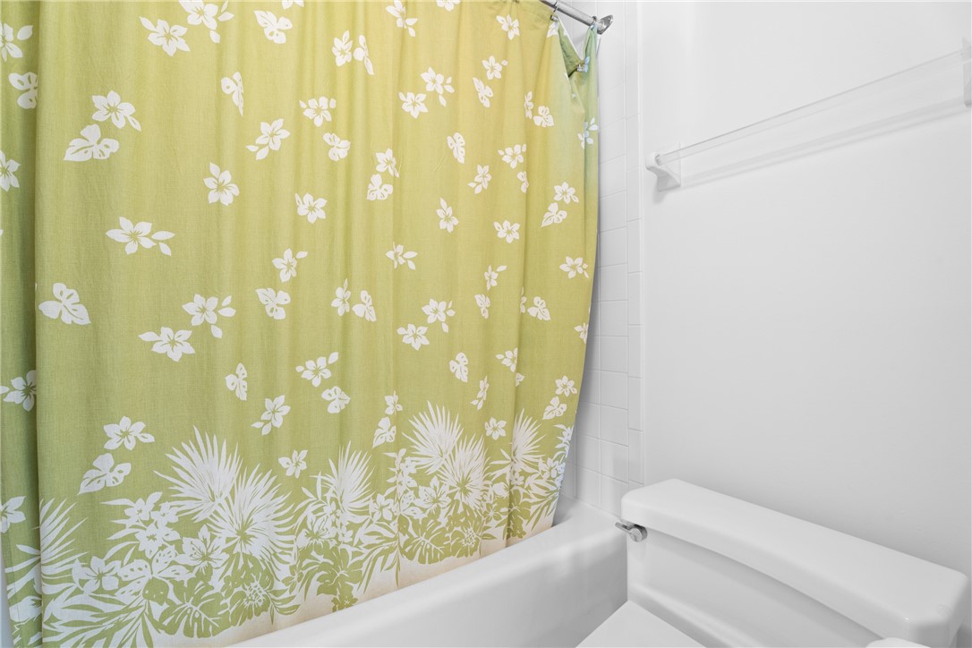 White ceramic bathtub with a shower curtain rod