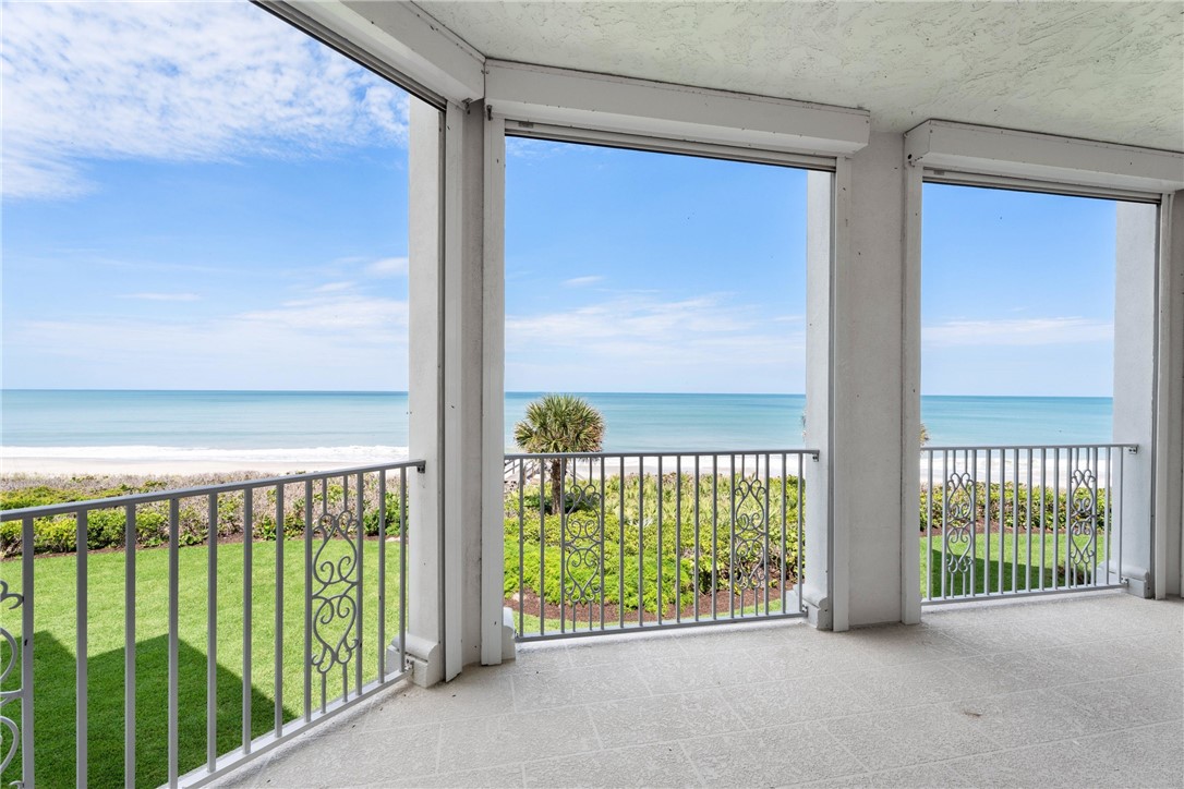 Expansive balcony featuring tiled flooring and decorative metal railings