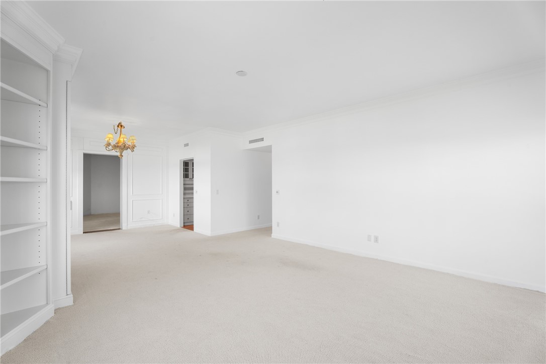 Bright interior space featuring light-toned carpeting and white walls