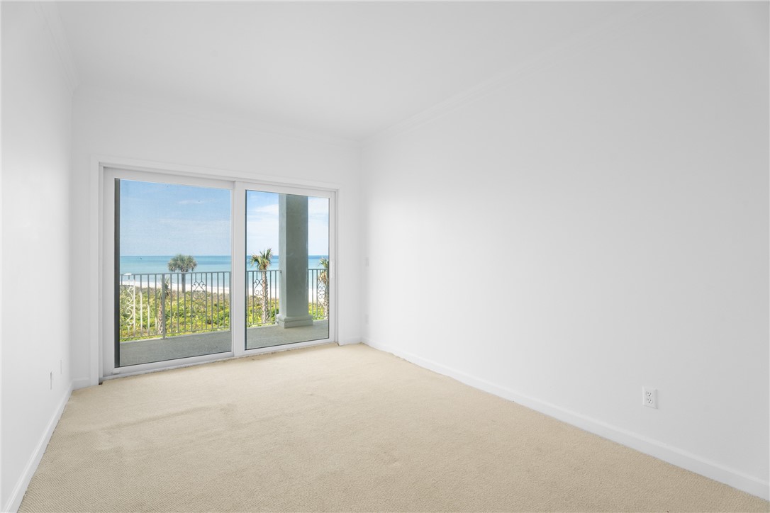 Sliding glass doors opening to a balcony with metal railing