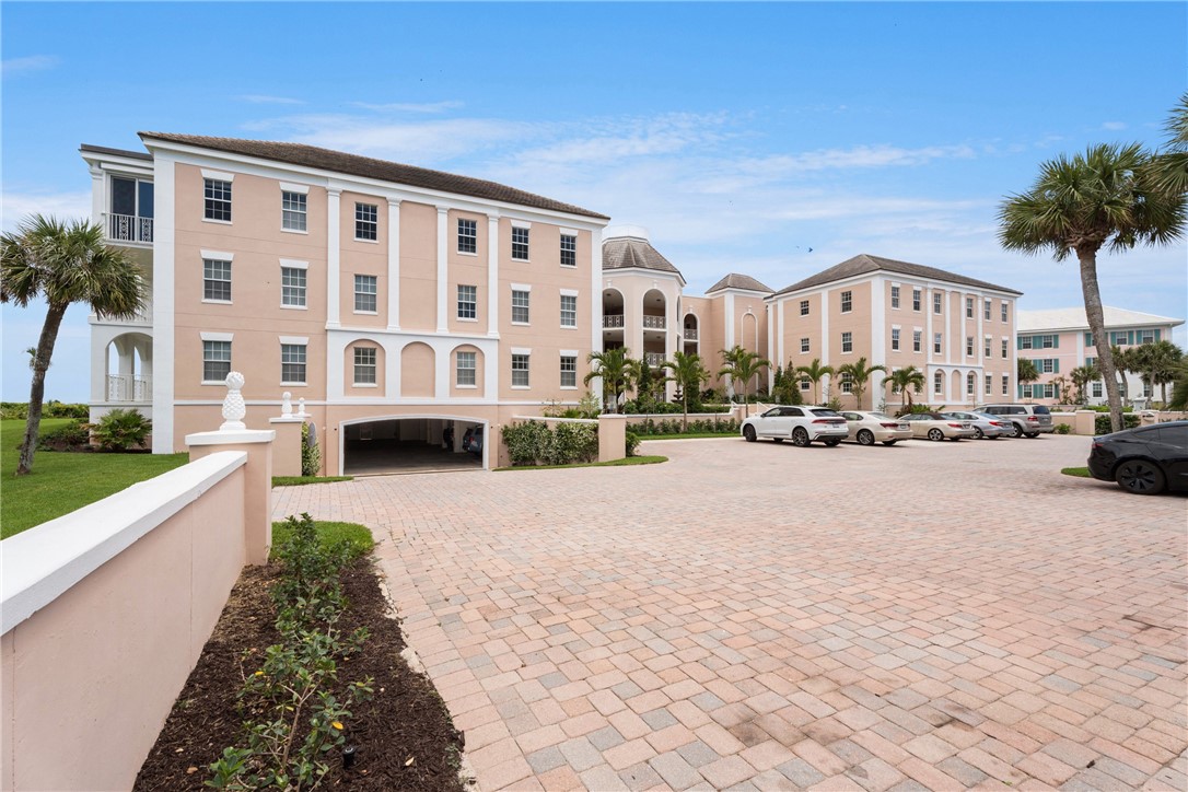 Multi-story residential buildings featuring classical architectural elements, light-colored exteriors, and a terracotta tile roof