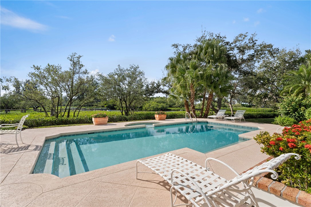 Rectangular swimming pool featuring integrated steps and a surrounding concrete deck