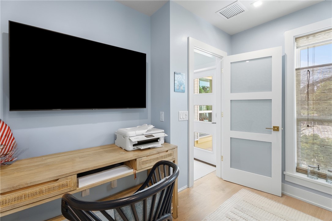 Light wood-finish flooring complements light blue wall paint