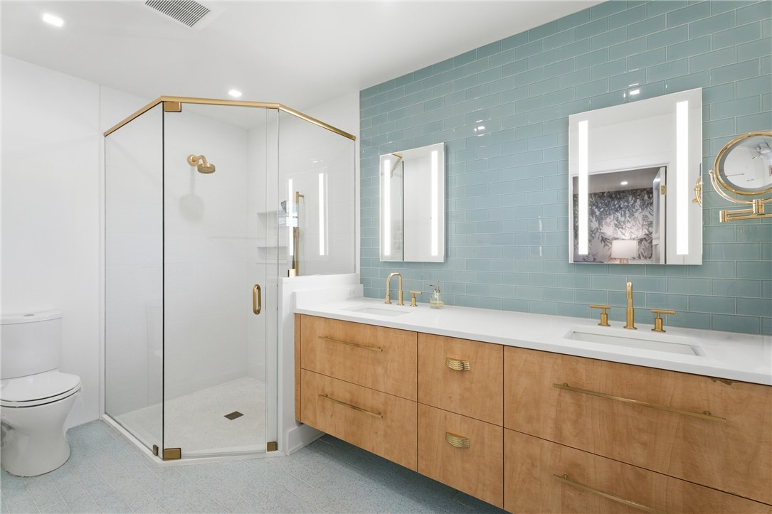 Double vanity with integrated sinks, quartz countertop, and natural wood-finish cabinetry