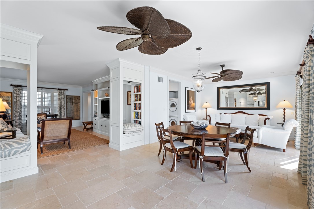 Travertine-style tile flooring extends throughout this open-concept living space