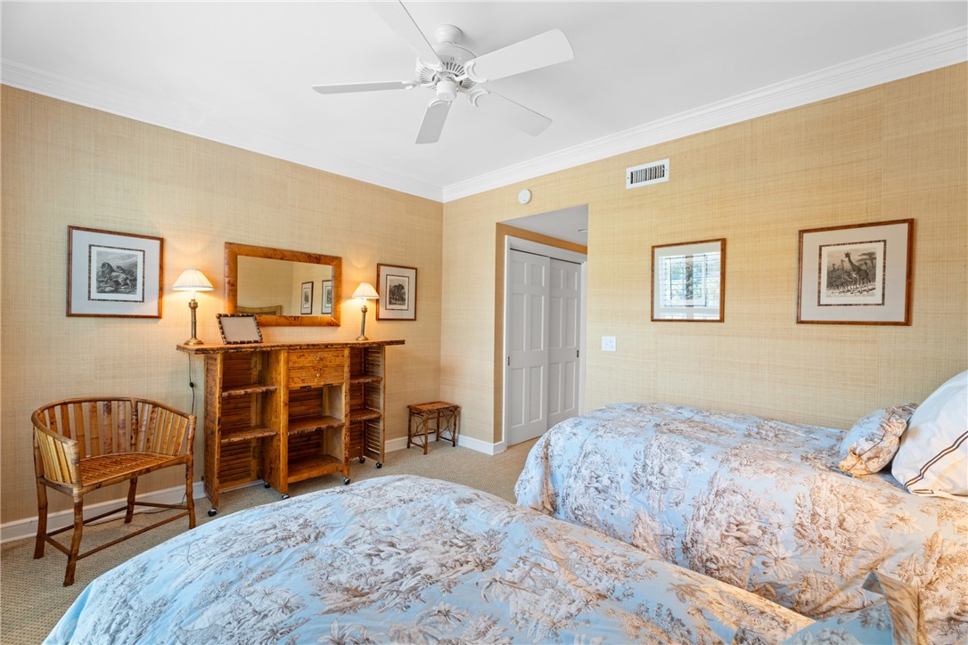 Carpeted interior with crown molding and textured wall finishes