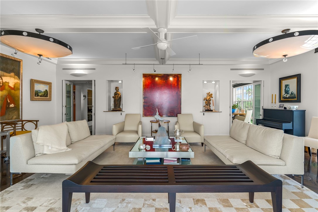 White coffered ceilings, built-in wall niches, and decorative ceiling fixtures