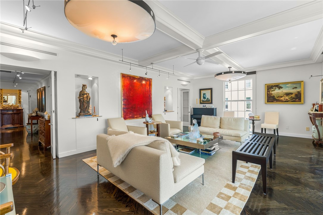 Coffered ceilings, recessed lighting, and dark wood-finish flooring