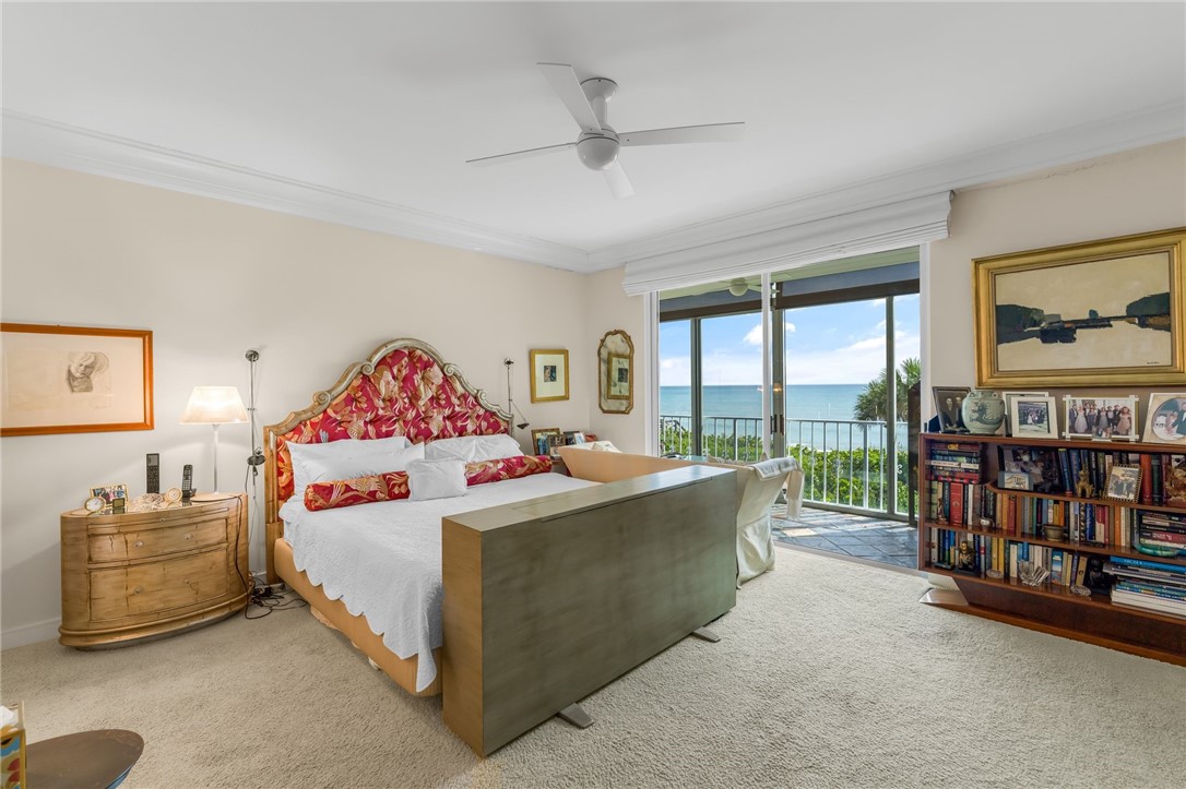 Spacious primary bedroom with dual nightstands, wood-frame bed, and coordinating upholstered headboard
