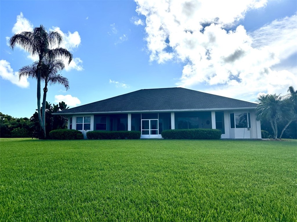 Expansive lawn with mature palm trees and established landscaping