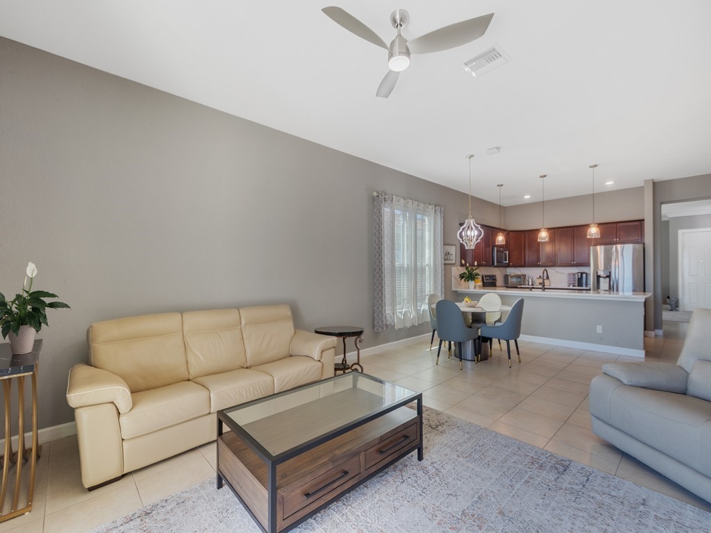 Recessed lighting, ceiling fan, tile flooring, kitchen island, and pendant lighting