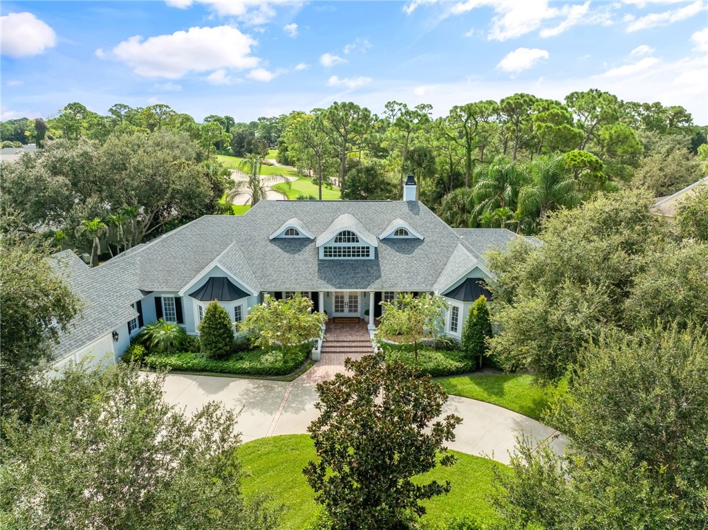 DISTINCTIVE CUSTOM ESTATE SHOWCASING TIMELESS ARCHITECTURE AND A GRAND CIRCULAR DRIVE ON .56 ACRES WITH GOLF VIEWS