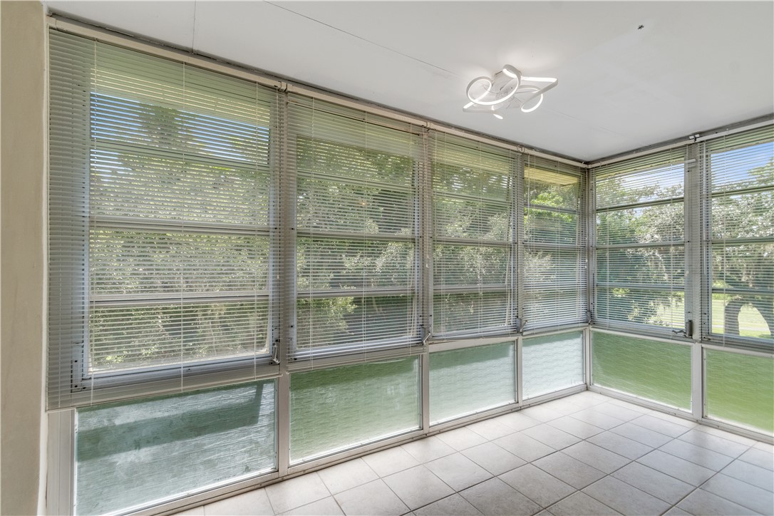 Spacious Sun Room w/view of golf course fairway & trees.