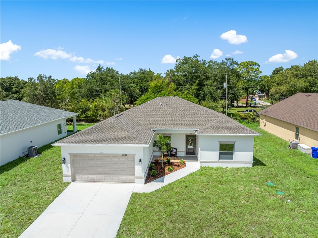Single-story home featuring a two-car garage, concrete driveway, and a covered entry