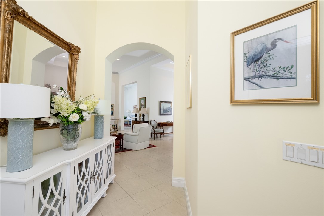 Arched entryway with tiled flooring and light-toned wall paint